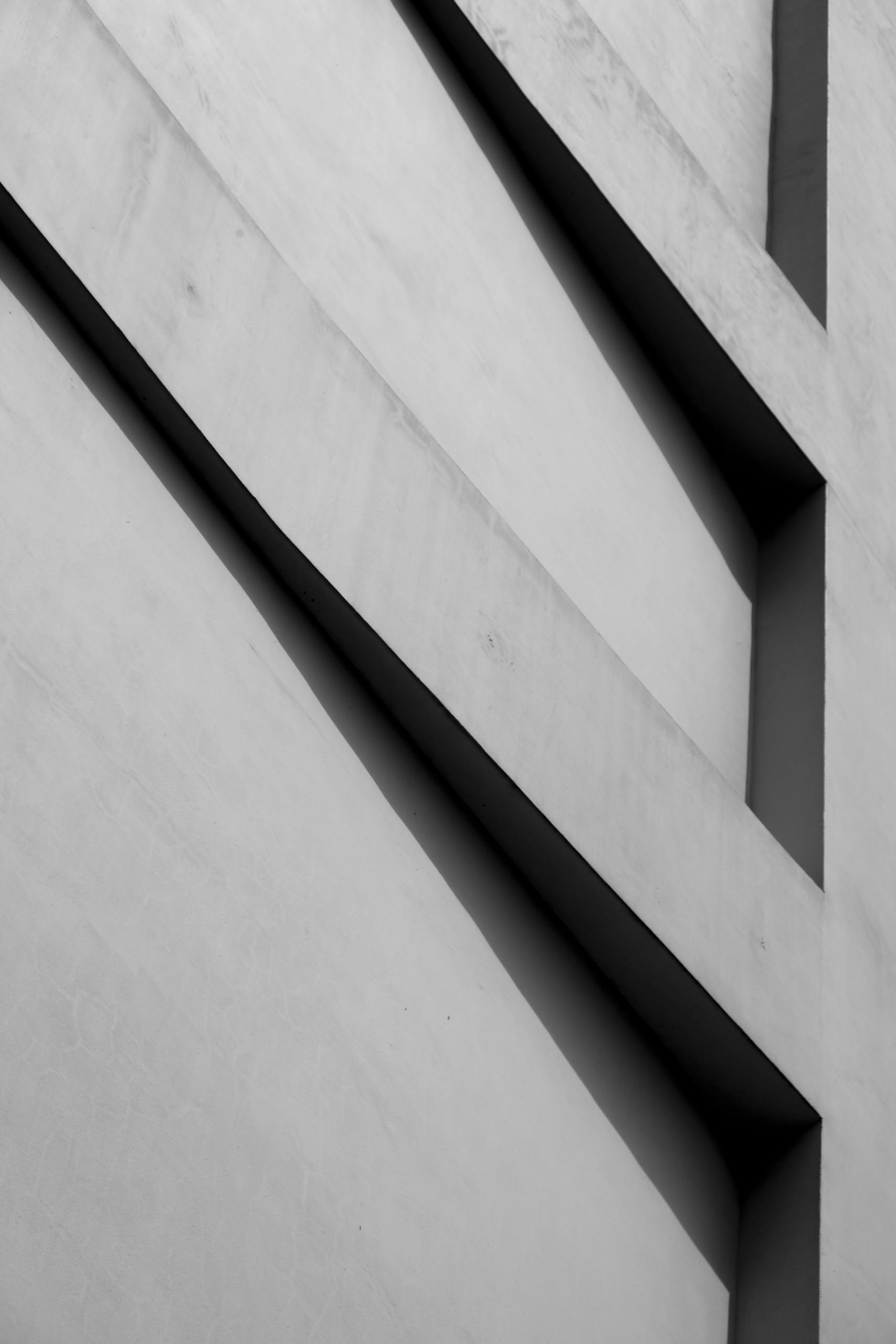 Black and white abstract architectural photo highlighting geometry and lines.